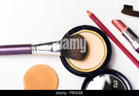 Eyeshadow cosmetics with brush and lipstick isolated on white Stock Photo