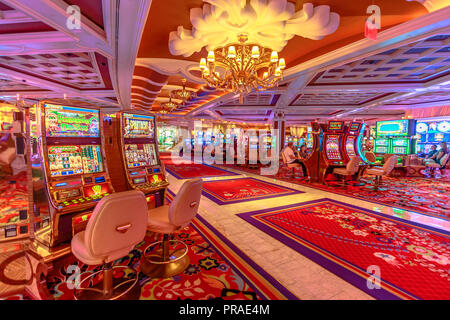 Las Vegas, Nevada, United States - August 18, 2018: people playing at the slot machine inside the Wynn in the Las Vegas Strip. Interior of luxurious Hotel and Casino Stock Photo