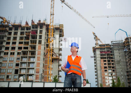 Architect on a construction site during a housing project Stock Photo