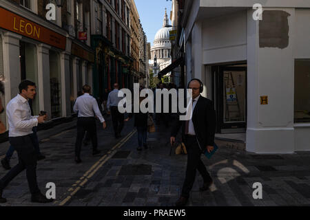 General street scene of London city workers going about their business during their lunch break close to St Paul's Cathedral London UK Stock Photo