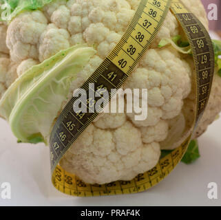 cauliflower with measuring tape on a white background Stock Photo