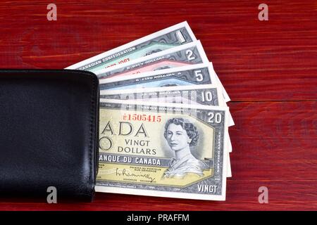 Old Canadian dollars in the black wallet Stock Photo