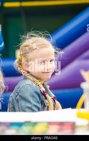 Portrait of a lovely smiling girl painting a picture Stock Photo - Alamy