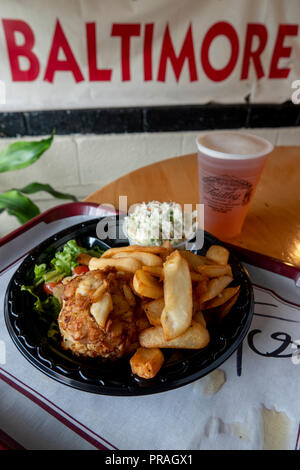 USA, Maryland MD Baltimore Lexington Market Faidleys Seafood lump crab meat crab cake with fries and cole slaw with a beer Stock Photo