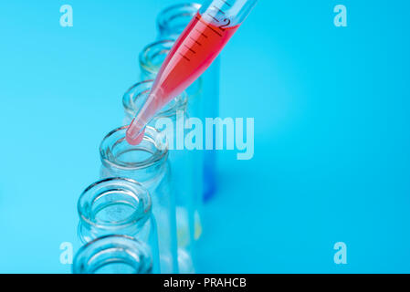 Dirty test-tubes on blue background. Research in the laboratory. Stock Photo