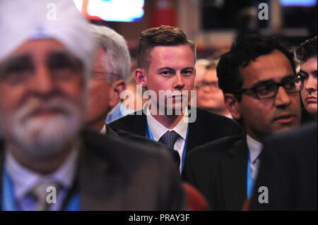 Birmingham, England. 30th September, 2018.  Young conservative delegate, listening to opening speeches at the first session of the first day of the Conservative Party annual conference at the ICC.  Kevin Hayes/Alamy Live News Stock Photo