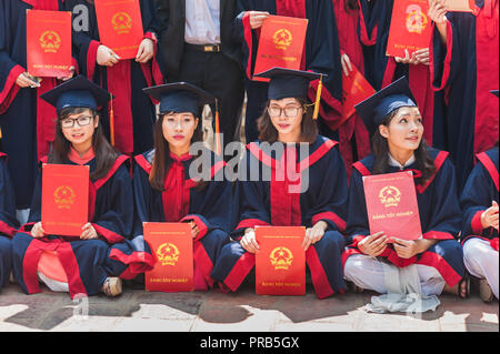 Hanoi, Vietnam - October 16, 2016. Group of students dressed in caps and gowns celebrating their university graduation. Temple of Literature. Stock Photo