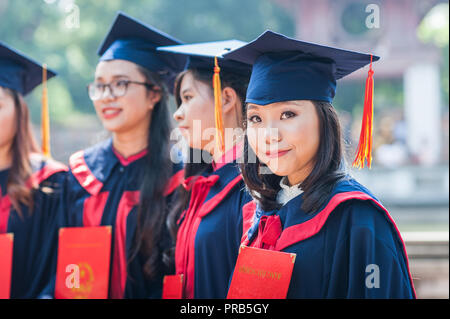 Hanoi, Vietnam - October 16, 2016. Group of students dressed in caps and gowns celebrating their university graduation. Temple of Literature. Stock Photo