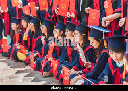 Hanoi, Vietnam - October 16, 2016. Group of students dressed in caps and gowns celebrating their university graduation. Temple of Literature. Stock Photo