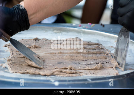 Rolled ice cream is a  frozen dessert that originated in Southeast Asia under the name "Thai rolled ice cream" or "stir-fried ice cream" Stock Photo