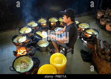 A man is making vegetarian rice pancakes at a Buddhist temple located in Tri Ton District, An Giang Province, VN Stock Photo