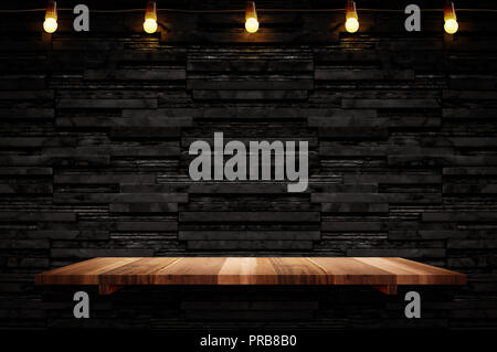 Empty brown plank wood shelf at black layer marble tile wall background,Mock up for display or montage of product or design. Stock Photo