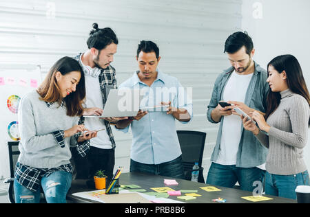 Diversity Designer in casual cloth using technology device at meeting table in meeting room at creative office Stock Photo