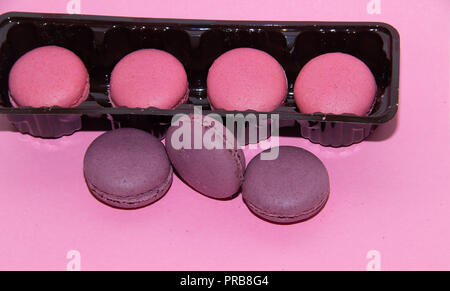 Macaroni on a gently pink background. Delicious cakes for tea. Dessert close-up. Bakery products. Stock Photo