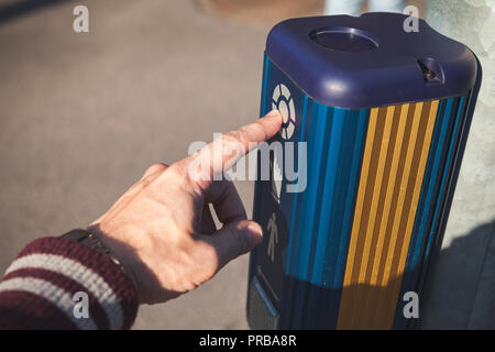 Male hand pushes pedestrian traffic light control button Stock Photo