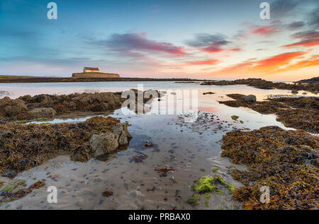 Sunset at Cwyfan Church on Anglesey in north Wales Stock Photo