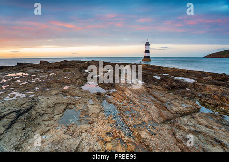 Sunset over the lighthouse at Penmon Point on the Anglesey coast Stock Photo
