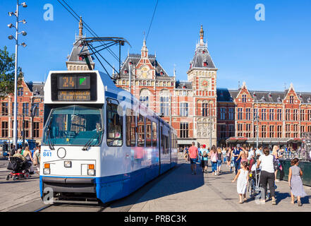 Amsterdam Central Station Amsterdam Train station amsterdam Centraal people crossing to the central station tram  Amsterdam Holland the Netherlands Stock Photo