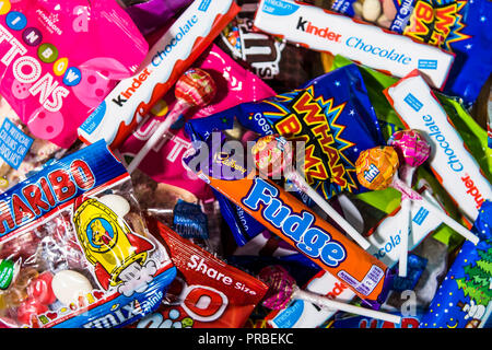 Assorted candy chocolate bars and sweets in brightly coloured wrappers. Stock Photo