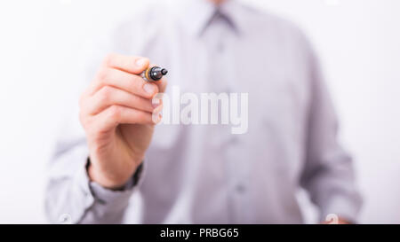 Male hand drawing something in empty space on imaginary glass surface. Stock Photo