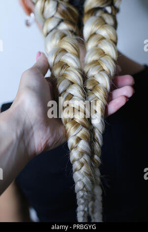 two thick braids of artificial hair, hairstyle youth, colored ha Stock Photo