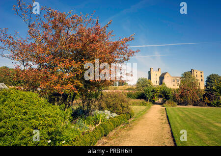 Helmsley Castle overlooking the Helmsley Walled Garden with a show of autumn flowers Stock Photo