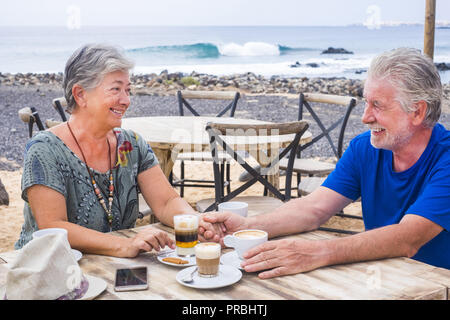 Successful retirement recreation, summer vacation concept. Retired mature couple enjoying a beautiful sunny day at the beach. Happy senior woman and m Stock Photo
