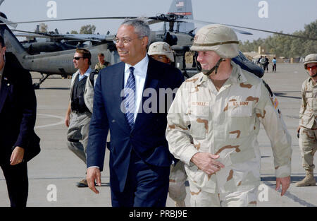 US Army Colonel William Mayville, Commander, 173rd Airborne Brigade (ABN BDE) welcomes US Secretary of State Colin L. Powell upon his arrival at Kirkuk Air Base (AB), Iraq. The Secretary is visiting numerous locations throughout Iraq including Baghdad, and Kirkuk to meet with the troops supporting Operation IRAQI FREEDOM. Stock Photo