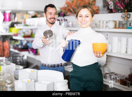 Young couple buys utensils for a house in a crockery store Stock Photo