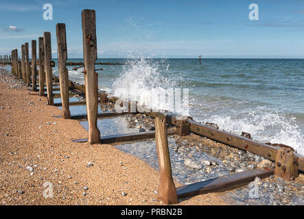 Wooden groynes and revetments, dilapidated on West Runton beach, North Norfolk. Stock Photo