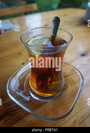 Azerbaijani Black Tea with Lemon in Tea Glass on Saucer Stock Photo