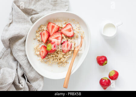 Oatmeal porridge with strawberries on white background. Healthy breakfast concept, healthy eating, lifestyle Stock Photo