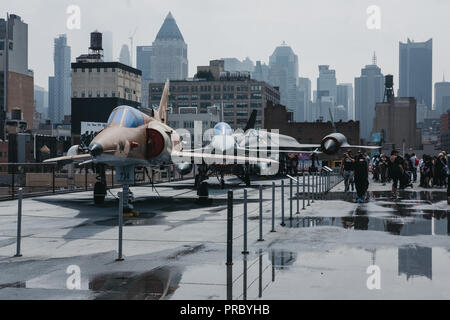 New York, USA - June 1, 2018: Planes and helicopters outside on the carrier in Intrepid Sea and Air Museum, an American military and maritime history  Stock Photo