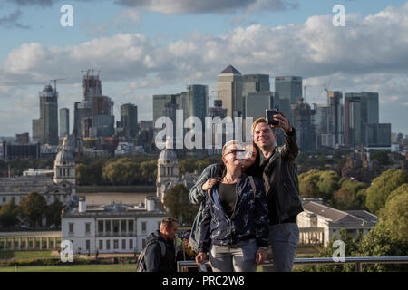 London Panorama from Greenwich Park, England UK. 22 September 2018 Taking selfie photographs with Canary Wharf as a backdrop. 20th and 21st cntury Can Stock Photo