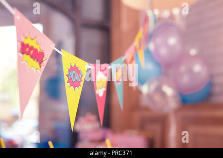 Bright laconic flags placed in the room for the party Stock Photo