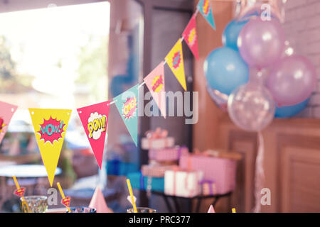 Beautiful photo of colorful party flags placed in the room Stock Photo