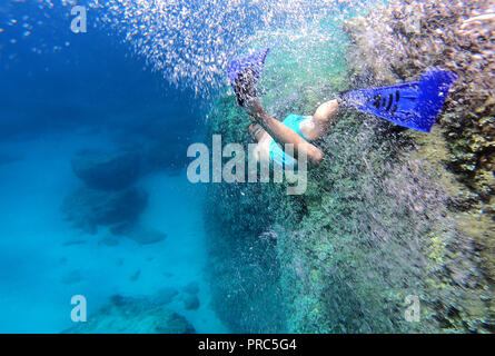 Snorkeling man swimming underwater in blue sea water Stock Photo