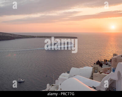 SANTORINI, GREECE - APRIL 12, 2017: Big cruise ship close to the shore of Santorini island, Greece Stock Photo