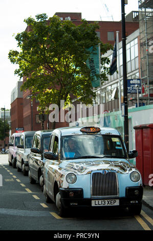 Cabs lined up by Harrow on the Hill station in the borough of Harrow in North West London Stock Photo