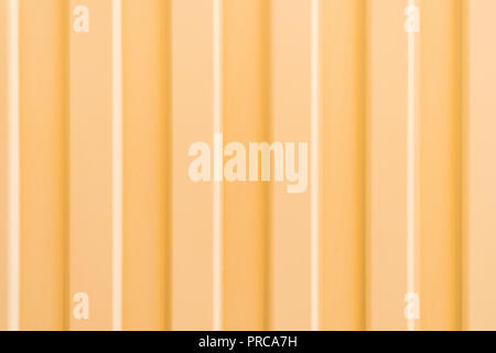 Texture of a profiled metal sheet painted in golden color, like a background Stock Photo