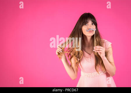 Girl with a funny black mustache. Festive decor. Stock Photo