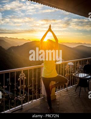 Young Indian girl doing Yoga . Surya Namaskar with mountain