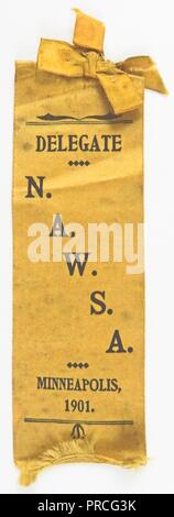 Yellow suffrage ribbon or badge, with a small bow at the top, issued to delegates attending the National American Woman Suffrage Association (NAWSA) convention in Minneapolis, manufactured for the American market, 1901. Photography by Emilia van Beugen. () Stock Photo