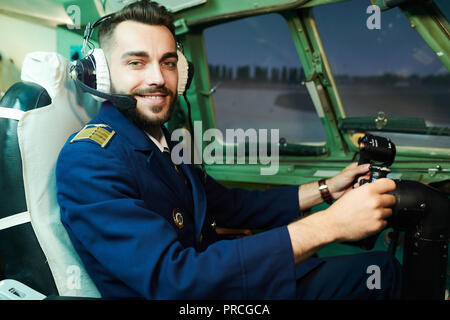 Smiling Pilot in Airplane Stock Photo