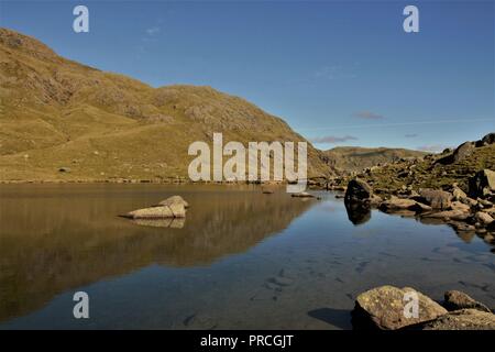 UK, Coniston Cumbria. View towards Low Water and Coniston Old Man from the Coppermines Valley Coniston Cumbria. Stock Photo