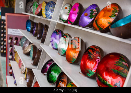 Decorated bowls made from coconut shells on sale at a souvenir shop. Stock Photo