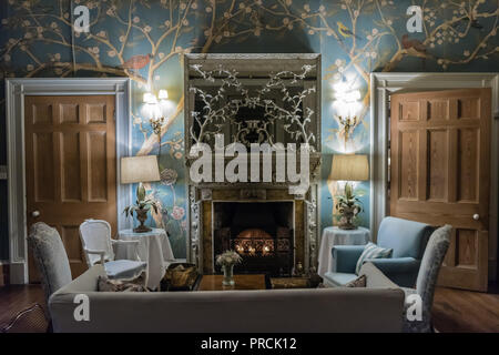 Sofas and chairs around the fire in an old-fashioned stately home. Stock Photo