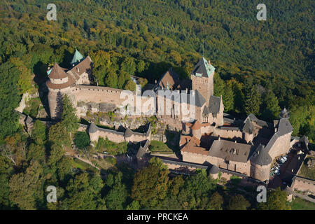 AERIAL VIEW. Pink sandstone medieval castle on a wooded mountain top. Haut-Koenigsbourg Castle, Orschwiller, Bas-Rhin, Alsace, Grand Est, France. Stock Photo