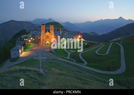 Sanctuary of Notre-Dame de la Salette at twilight with the alpine mountains for background. La Salette-Fallavaux, Isère, Auvergne-Rhône-Alpes, France. Stock Photo