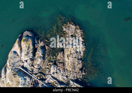 Aerial view of a rocky coatline with claer ocean on Vancouver Is